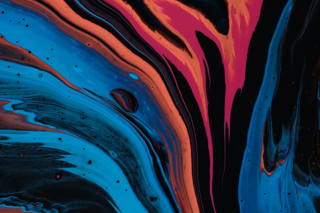 A close view of red and blue fluid paint